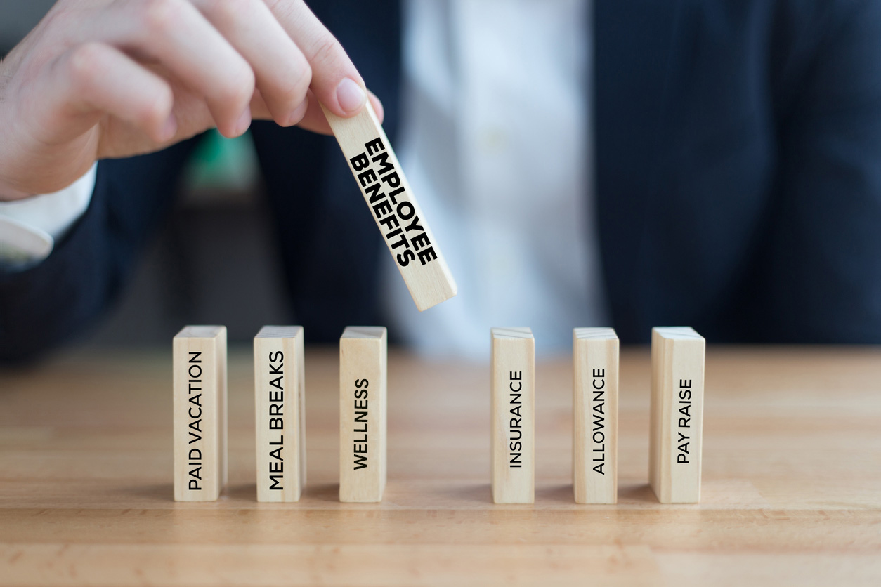 Shot of a man with wooden blogs shows how important benefits administration is with smart benefits to maximize value